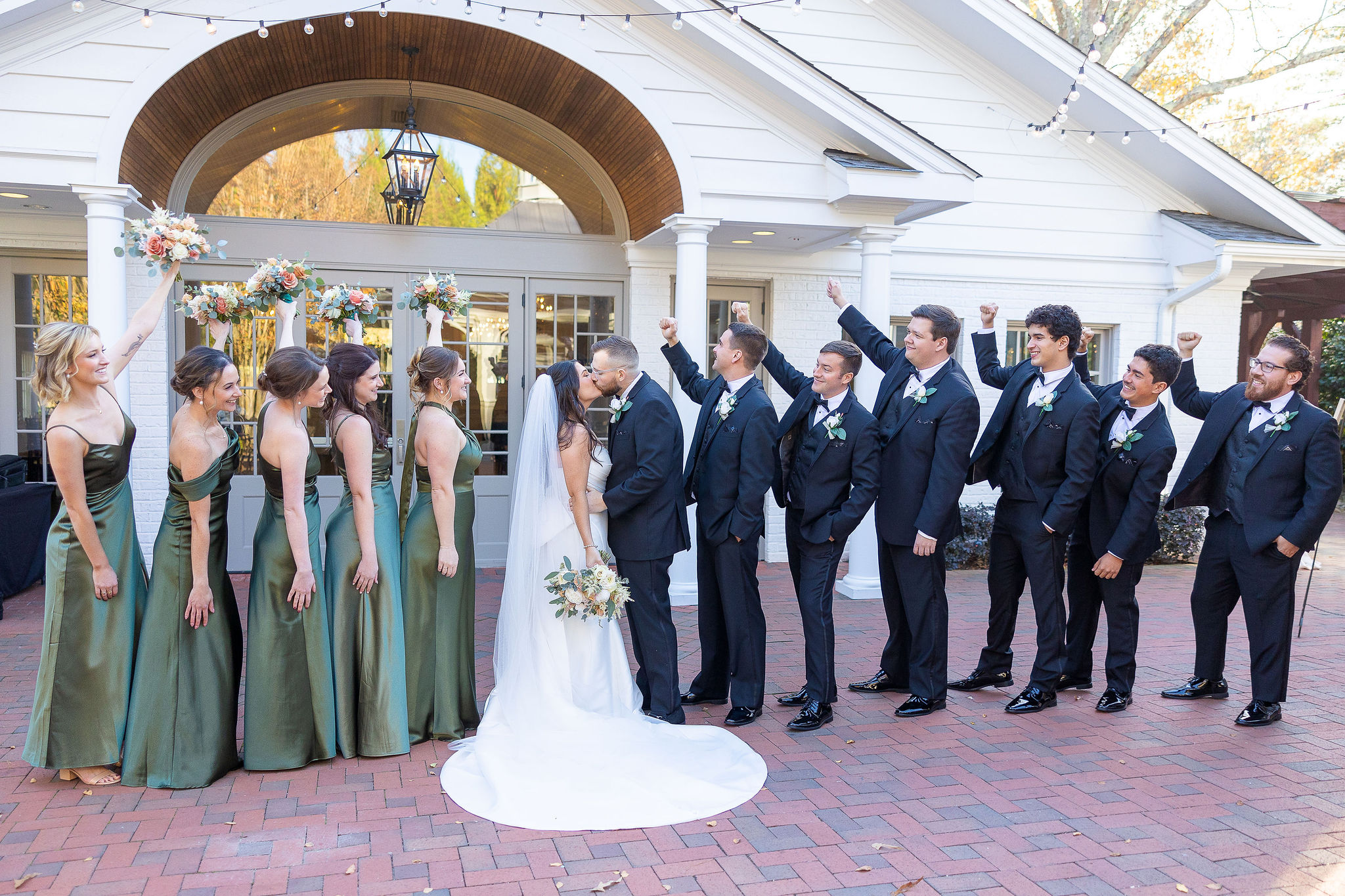 Bride and groom with their bridal parties on each side of them outside