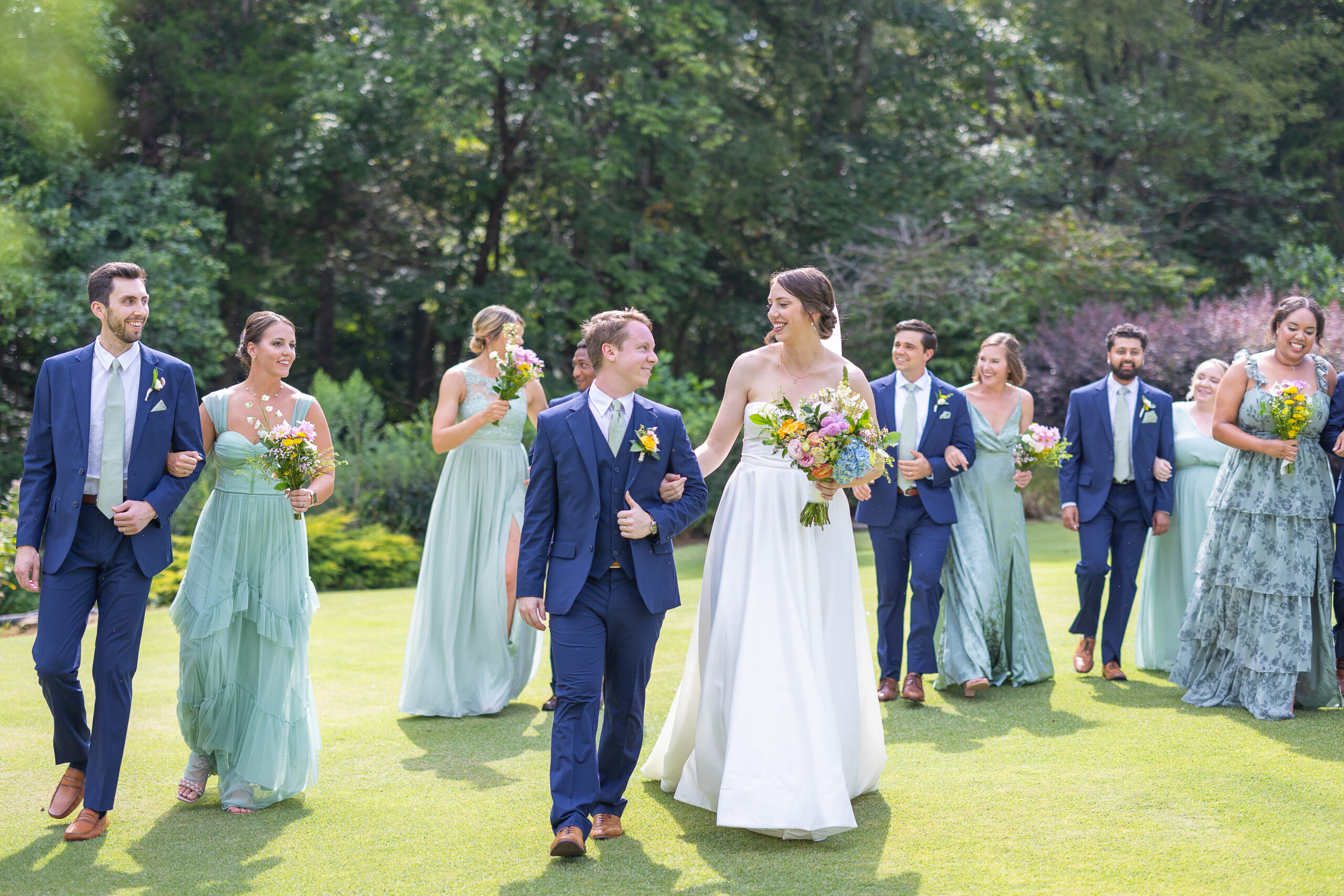 Bridal Party Walking on Golf Course with Bride and Groom