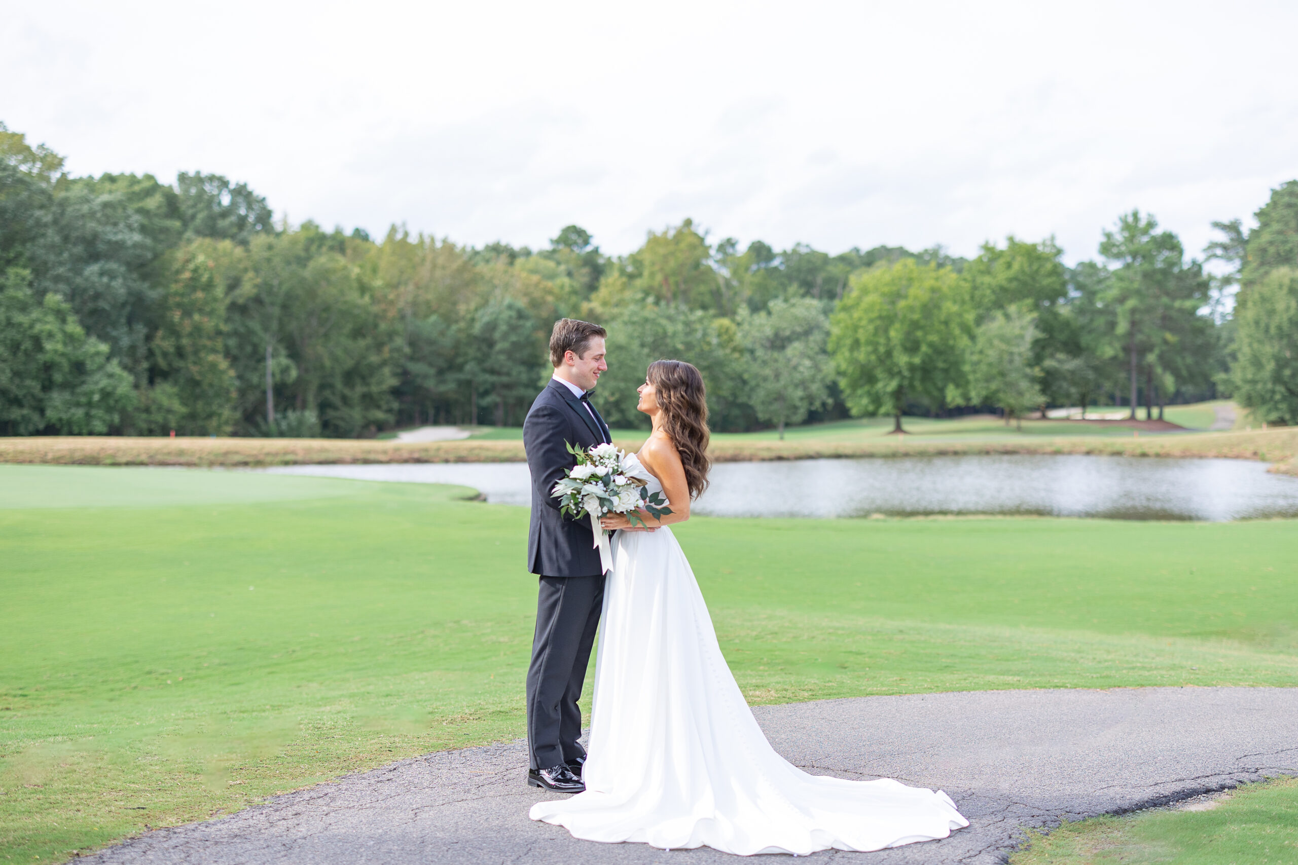 Bride and Groom on Golf Course in Wedding Attire