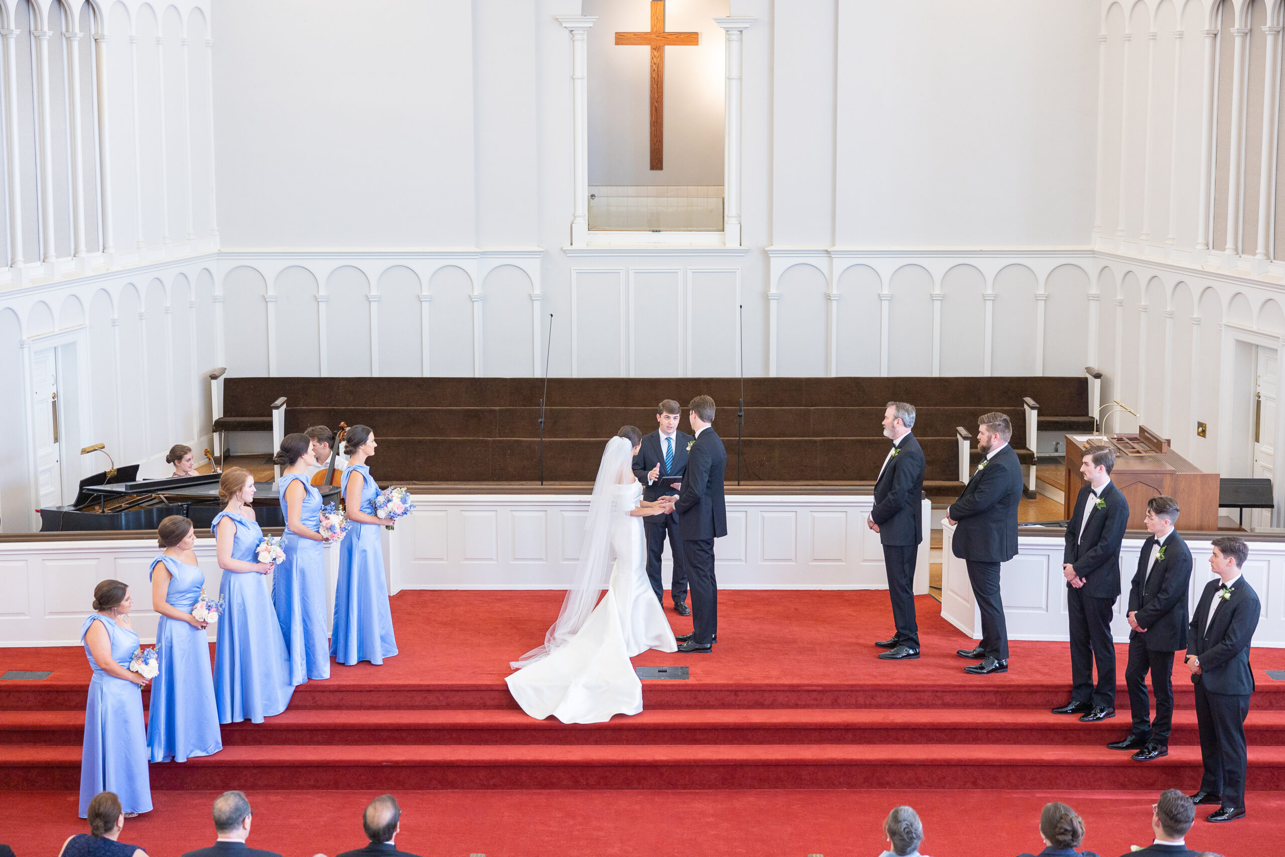 Couple at the alter with bridal parties on each side