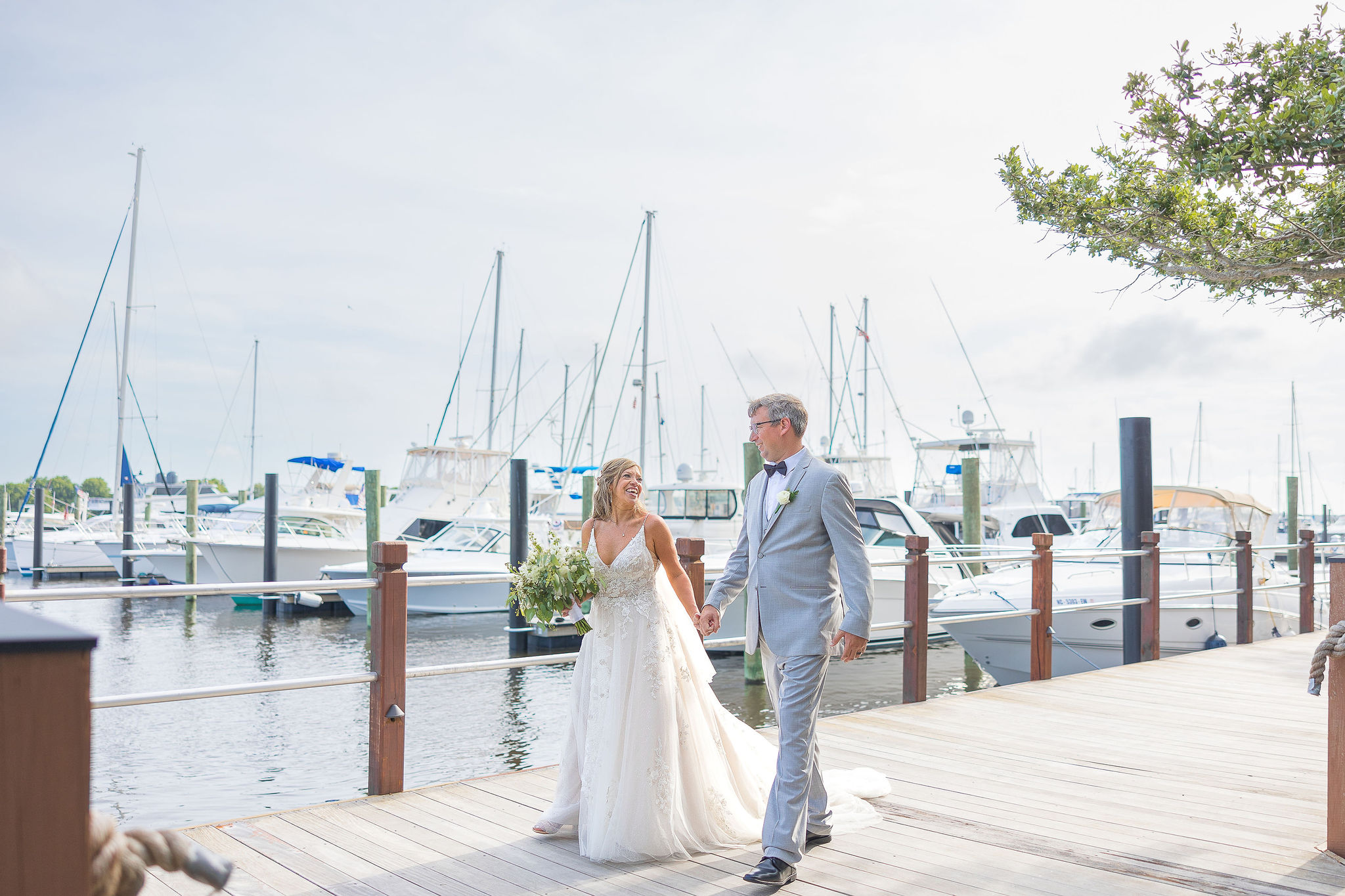 Couple Walking on Southport boardwalk in Wedding Attire