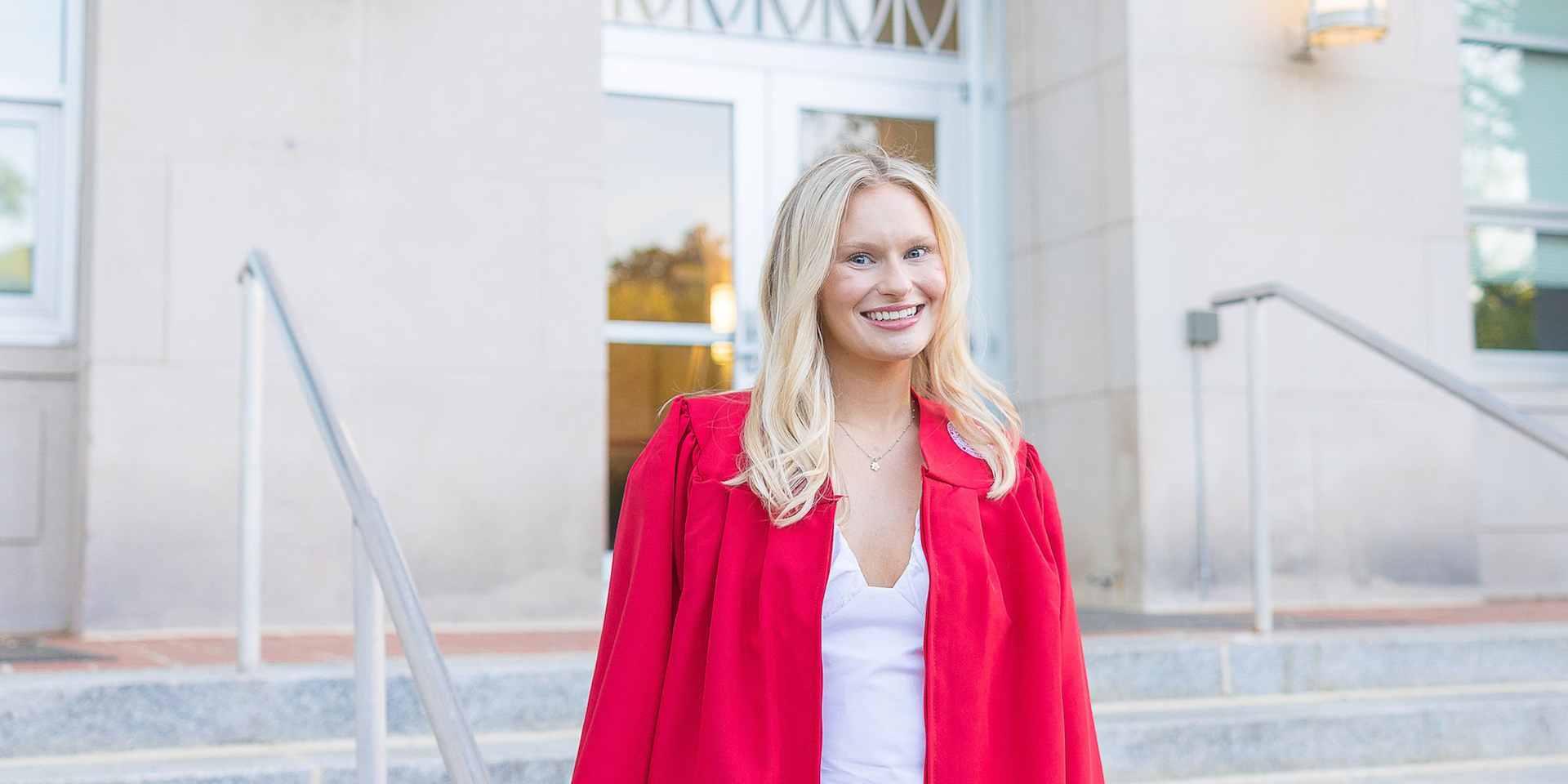 Blonde girl standing on steps of NC States Poole College of Management