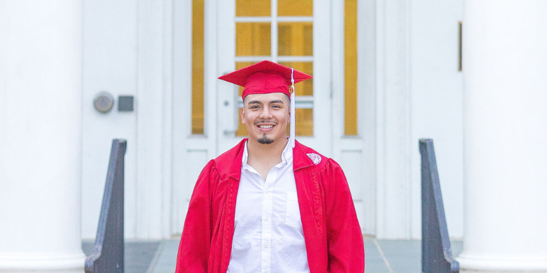 Guy with red cap and gown on