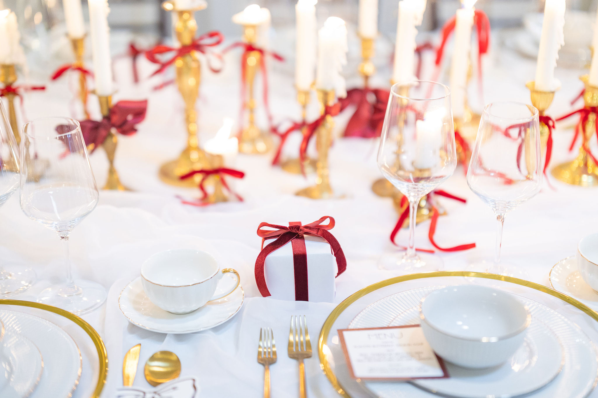 Red and gold tablescape at wedding reception