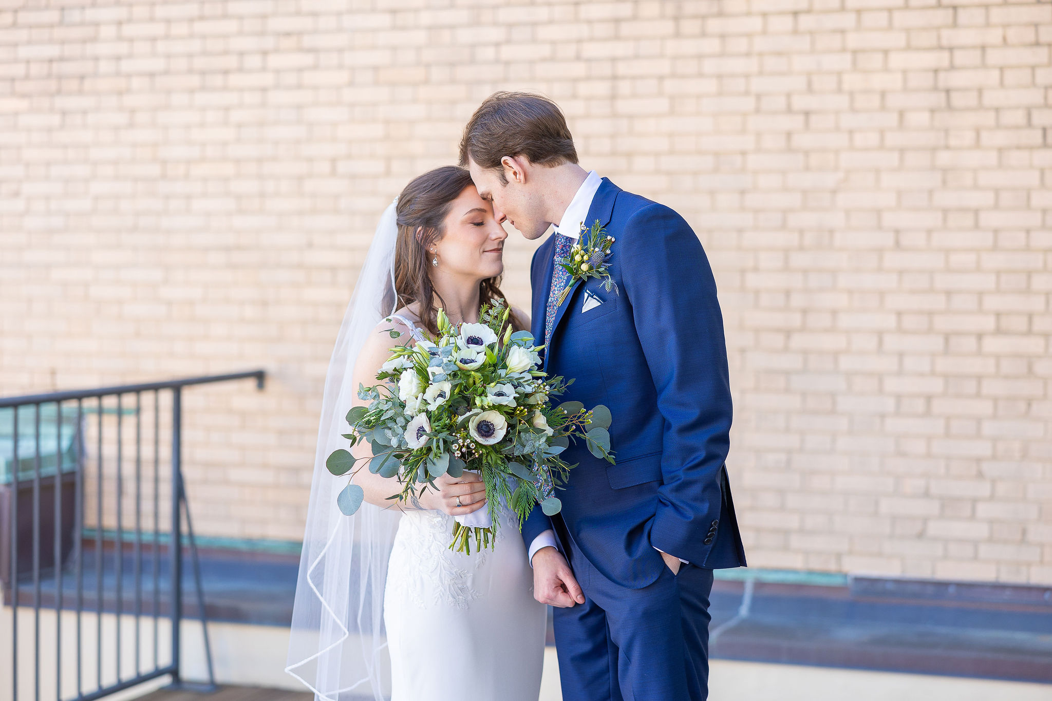 Bride and groom with bouquet of flowers