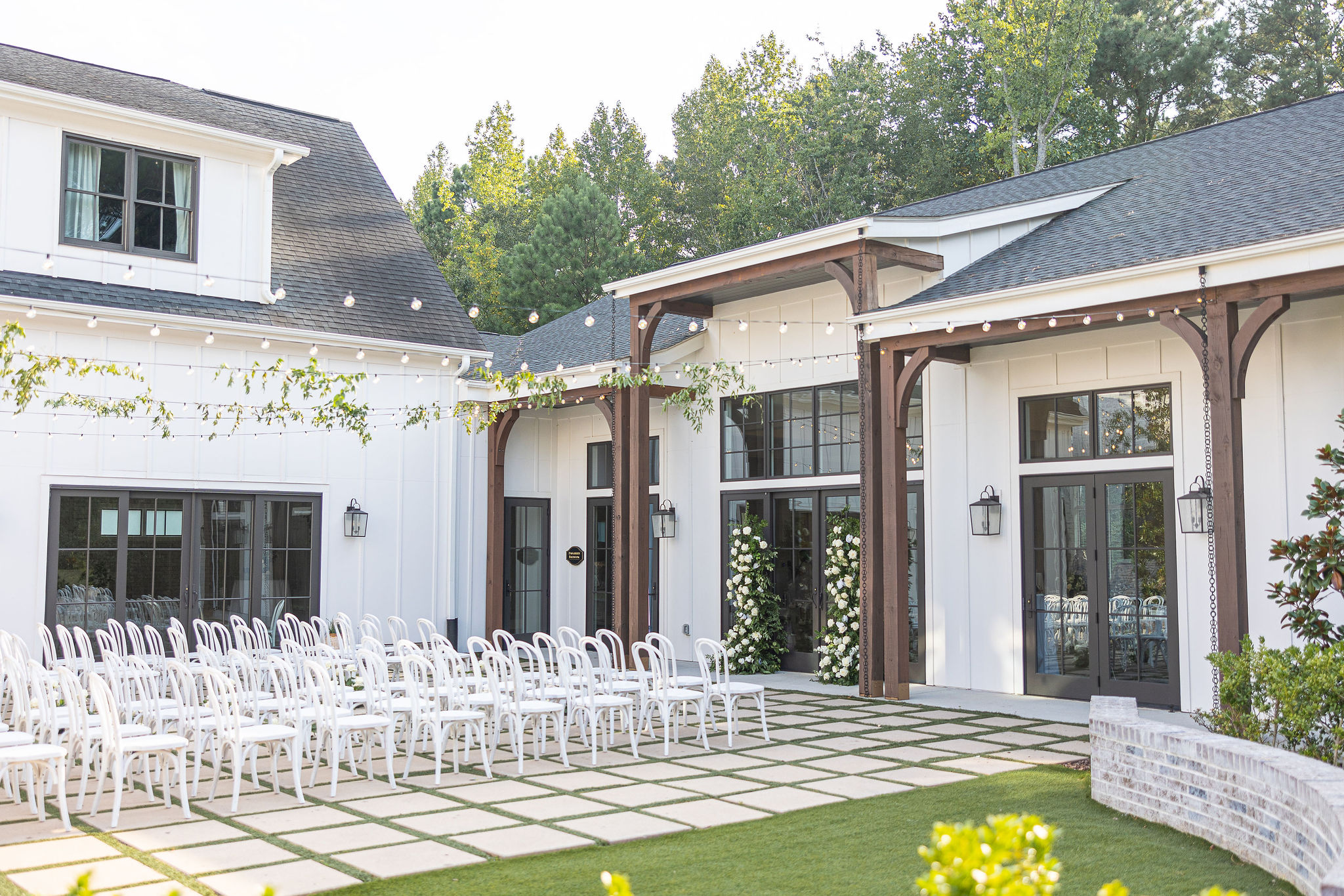 An outdoor wedding venue with chairs lined up