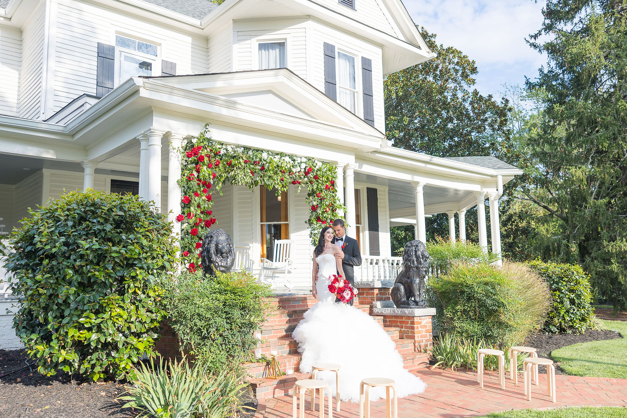 Bride and Groom on steps in front of house