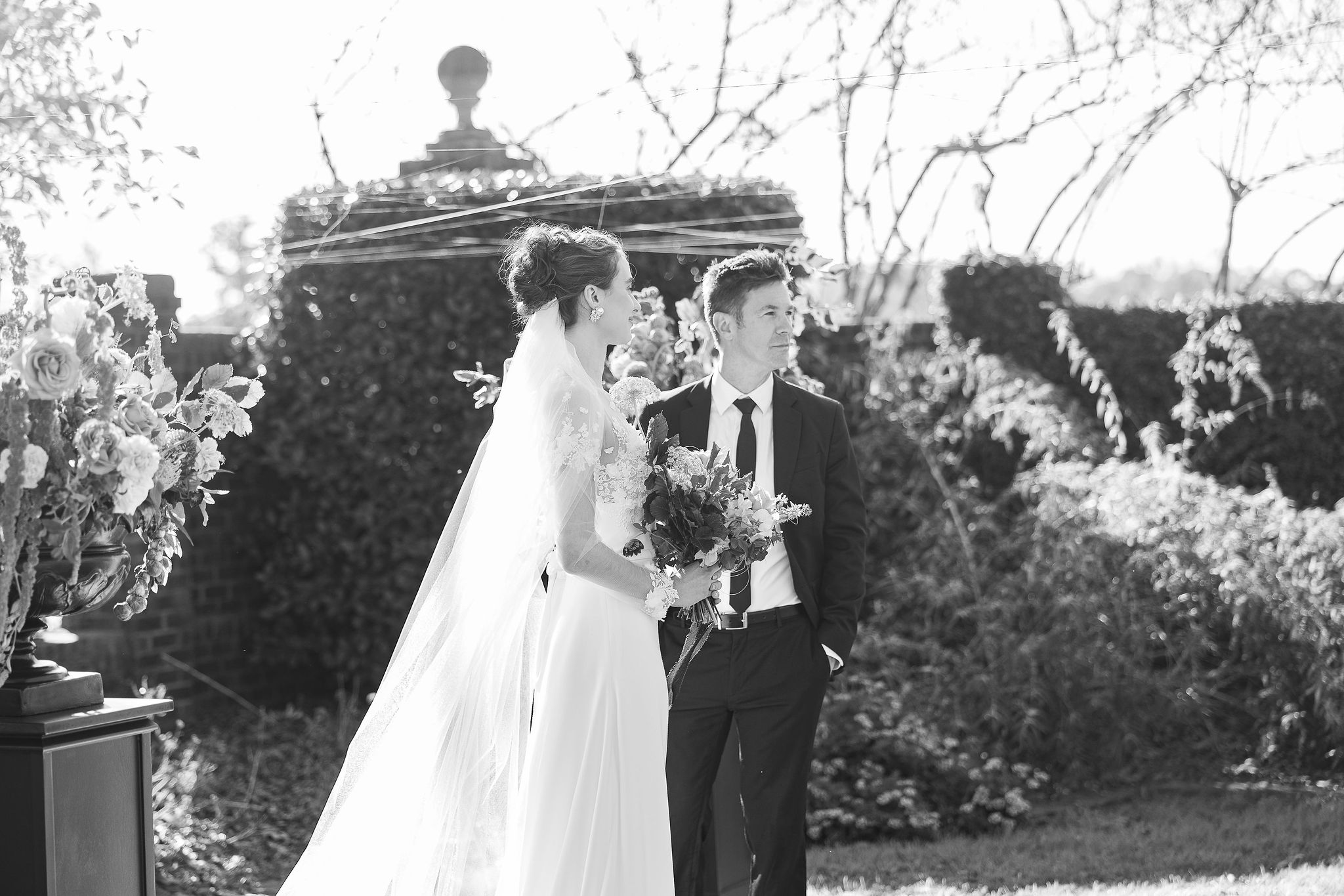 Black and white picture of bride and groom in garden