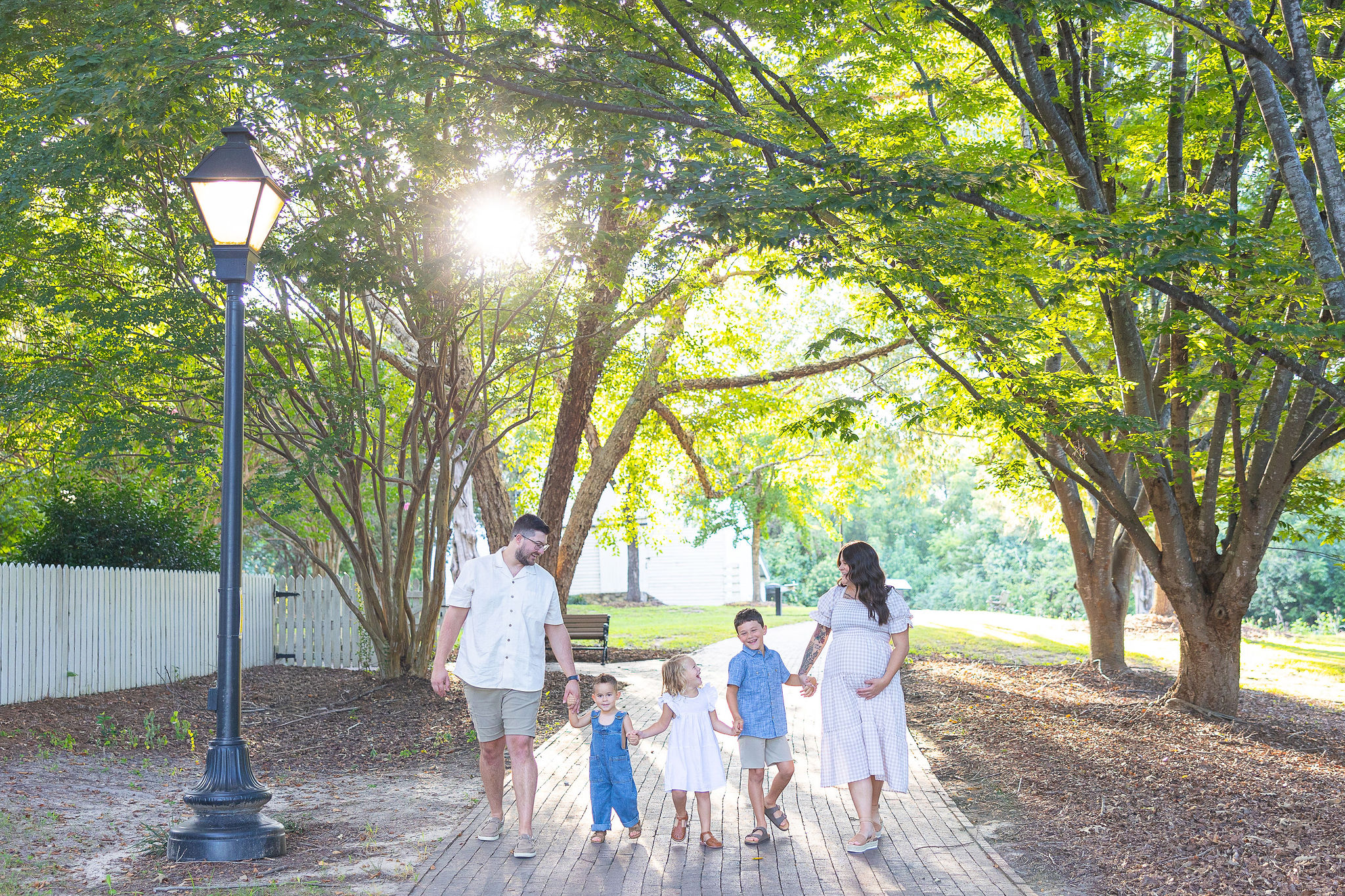 family holding hands and walking in the park together