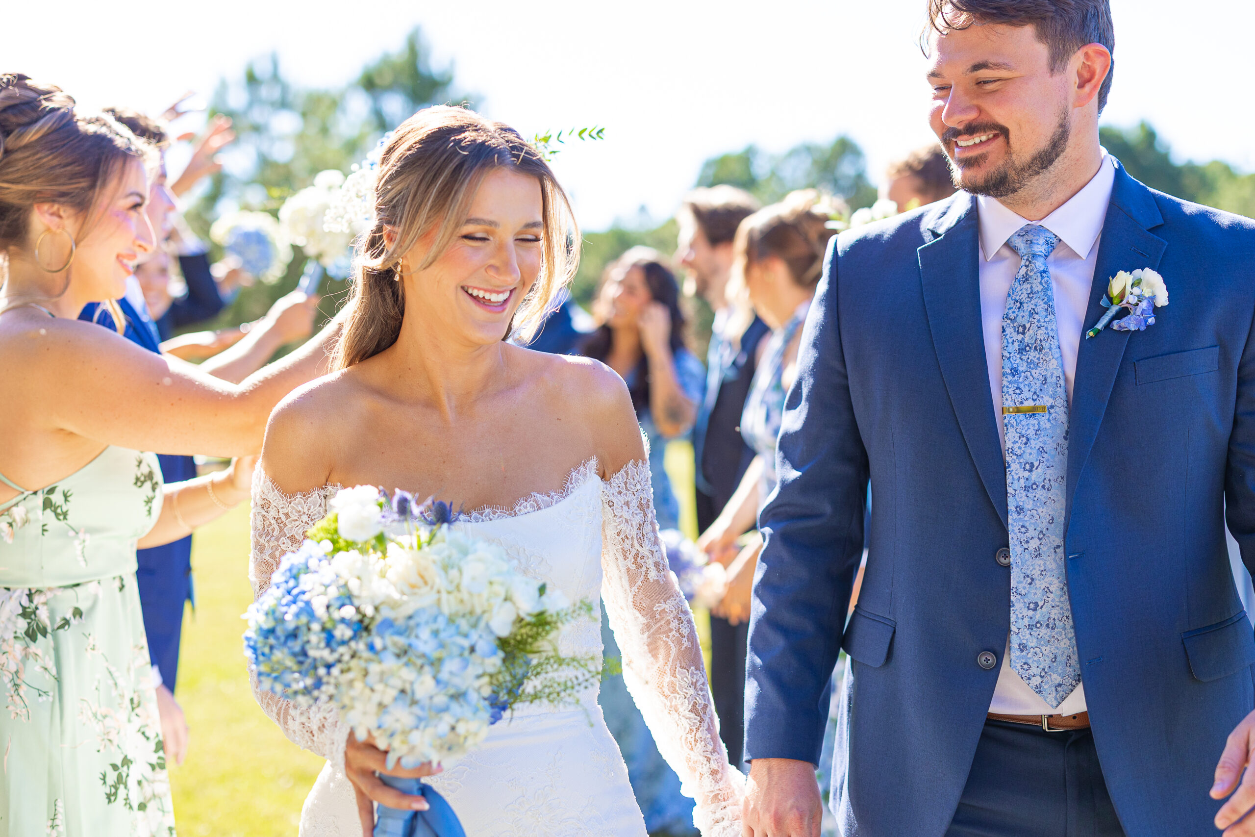Bride & Groom walking through bridal party tunnel
