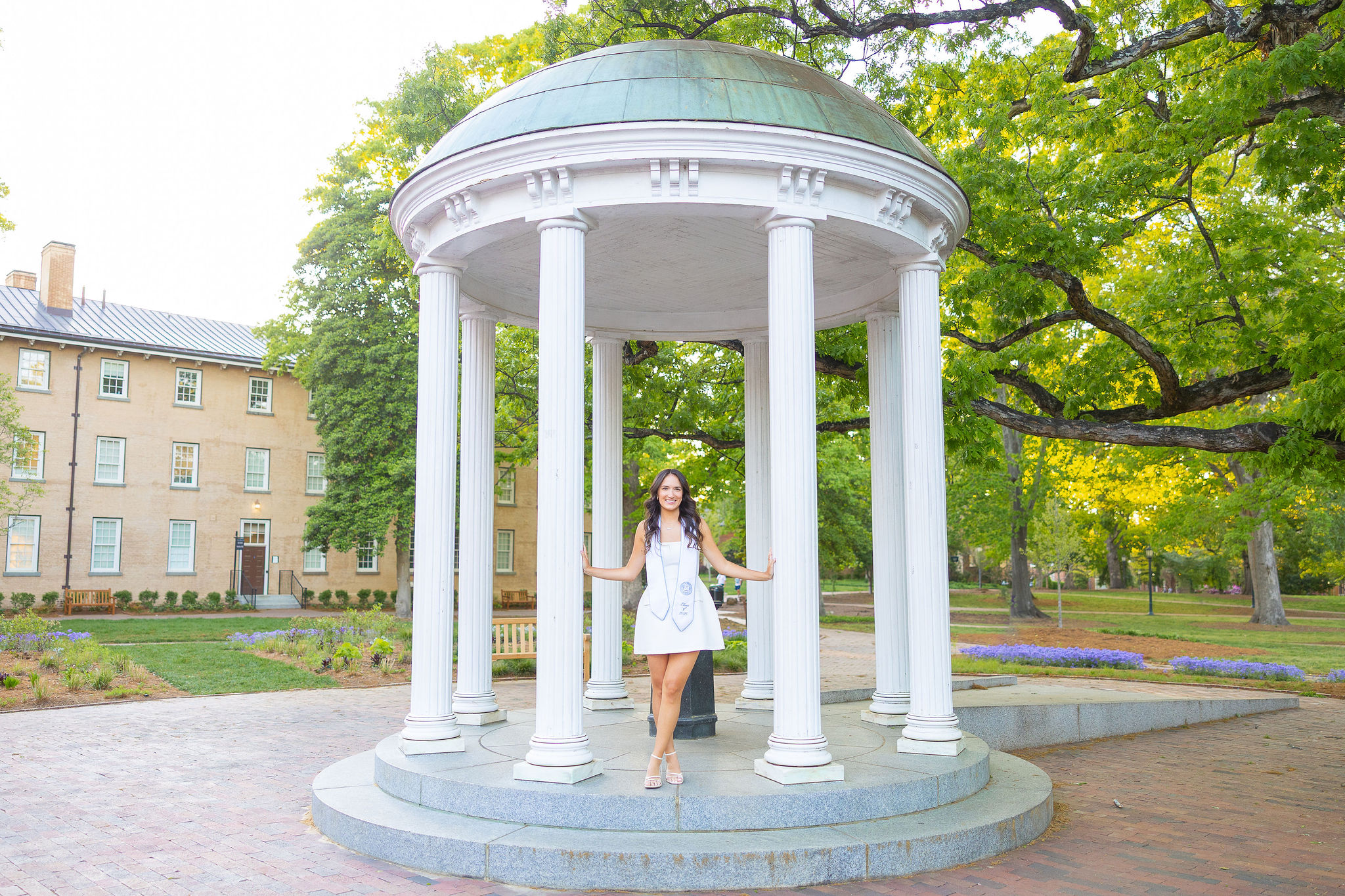 UNC Grad standing at old well