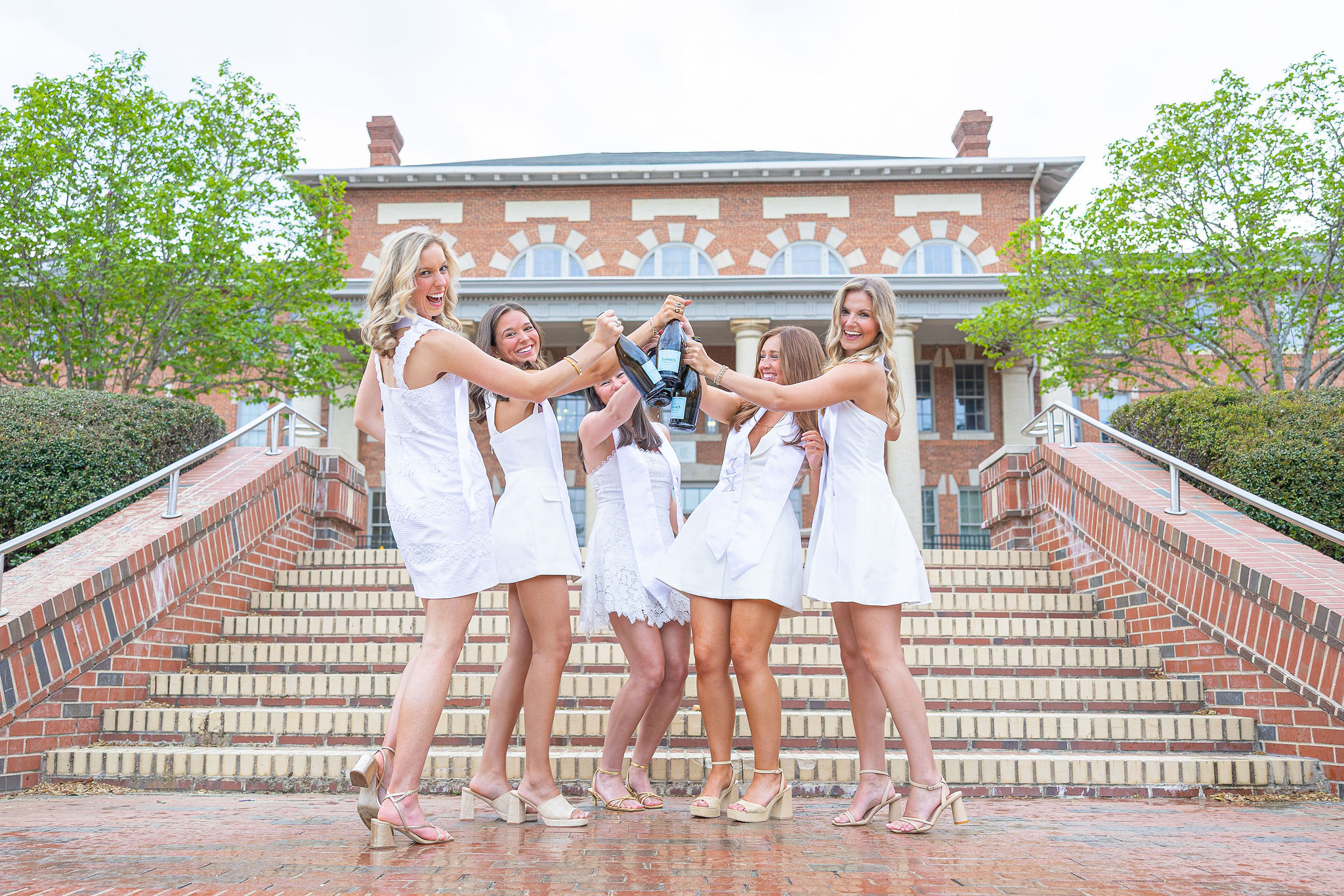 NC State group pictures at court of carolina with champagne