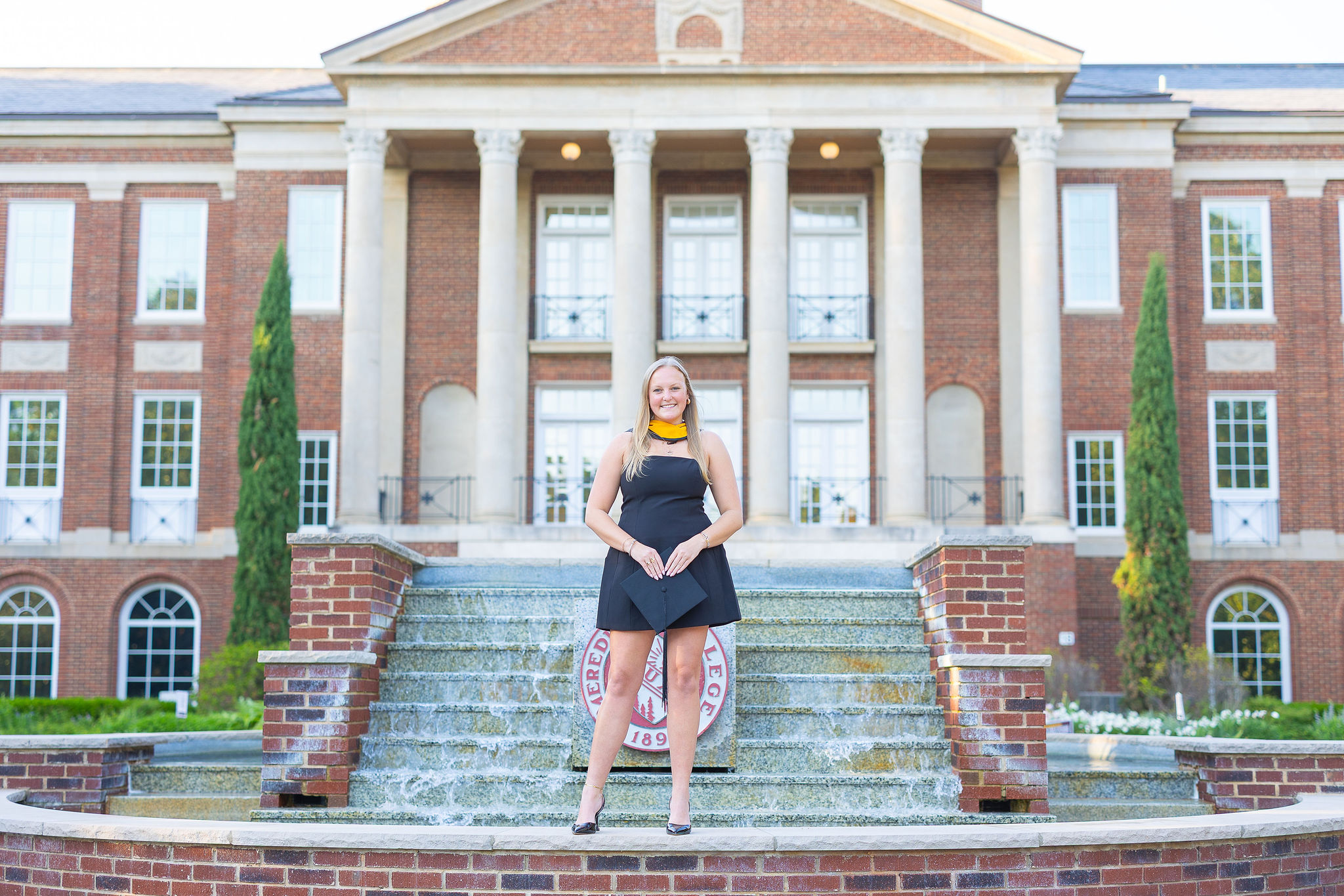 Meredith college senior in front of the fountain