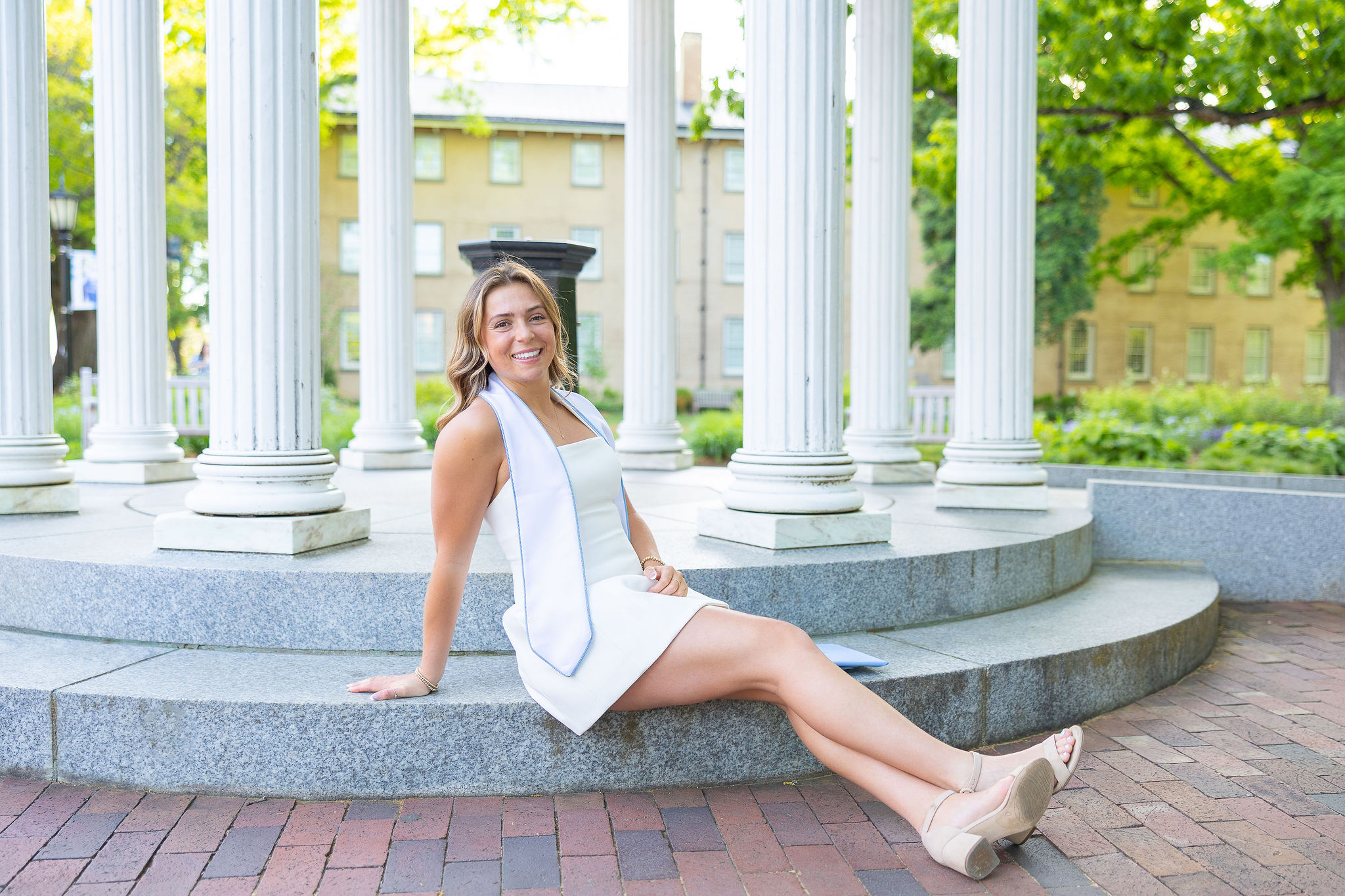 UNC Graduate sitting on belltower steps