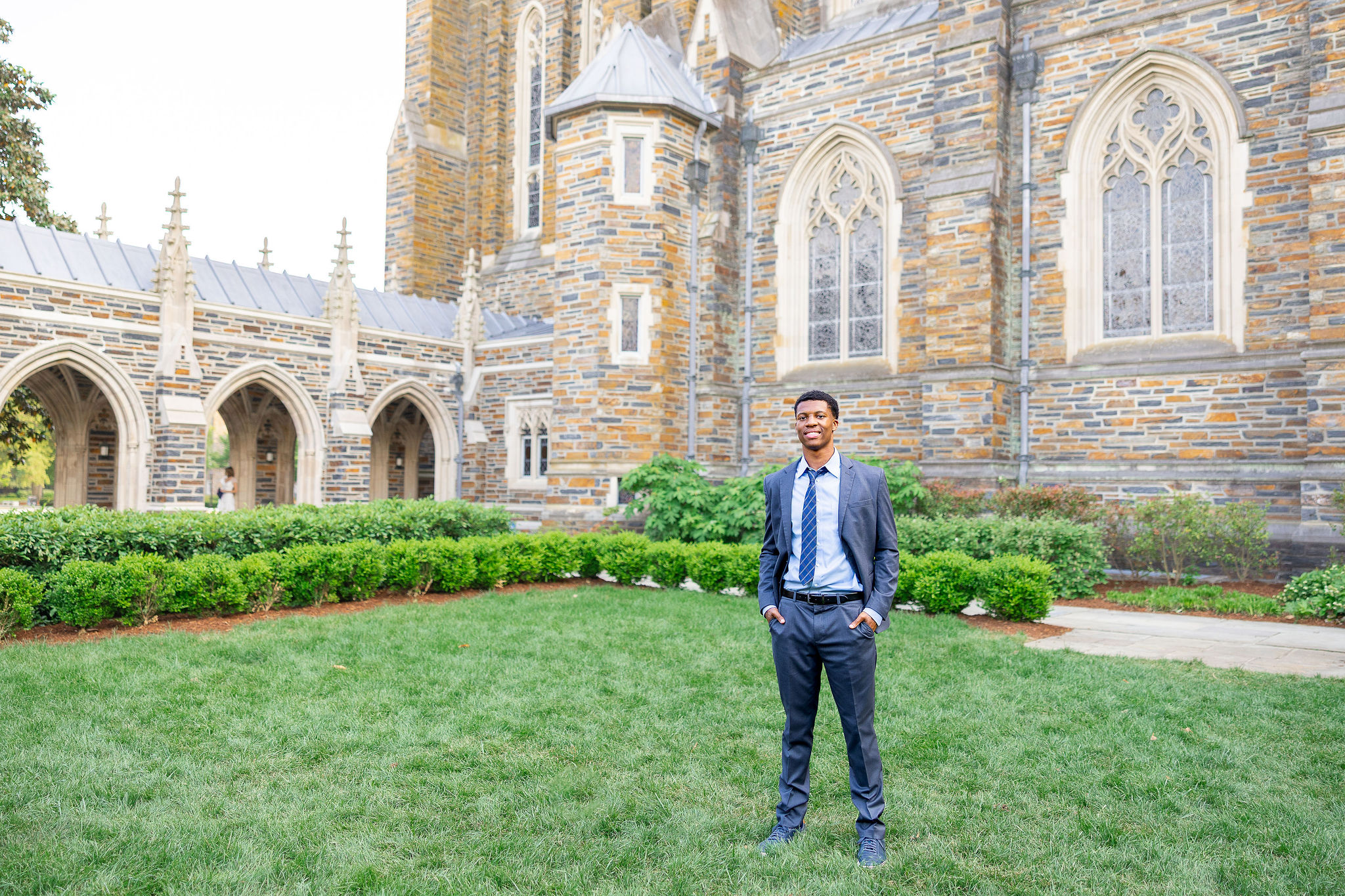 Duke University Graduate standing in front of Duke Chapel