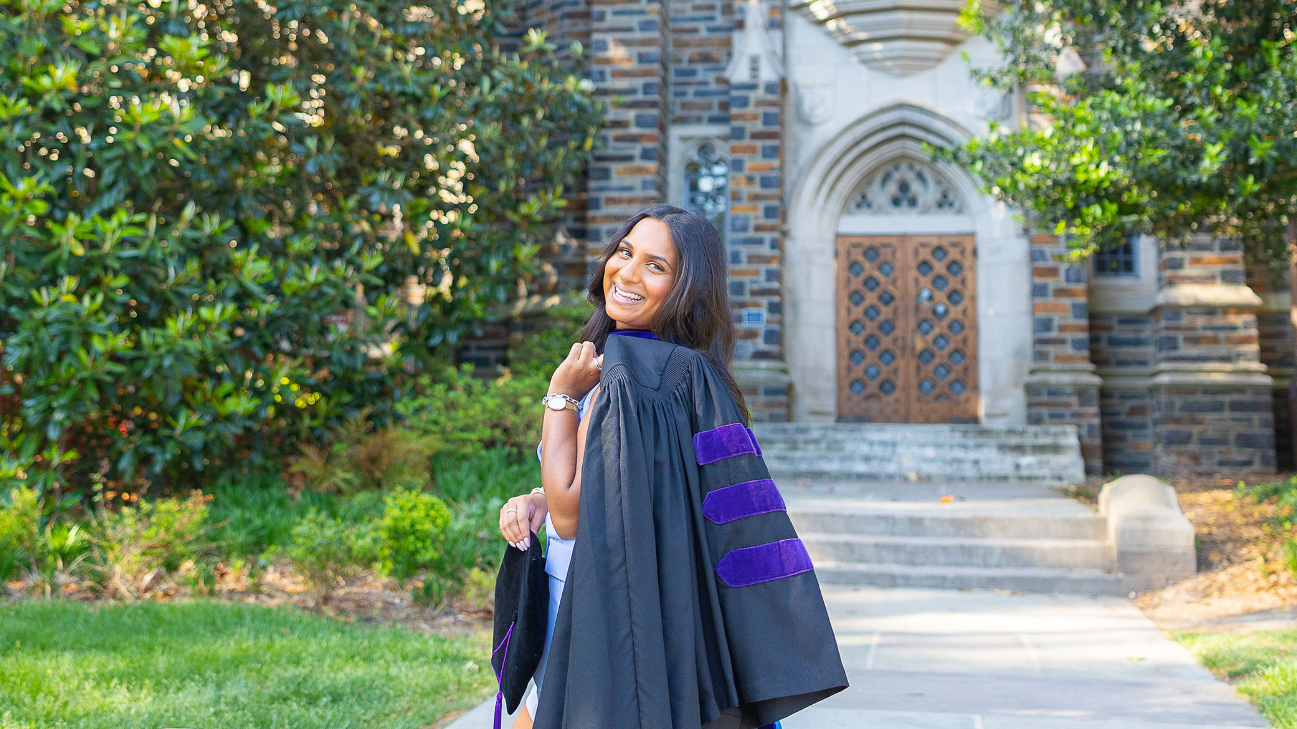 duke law school graduate with gown over one shoulder