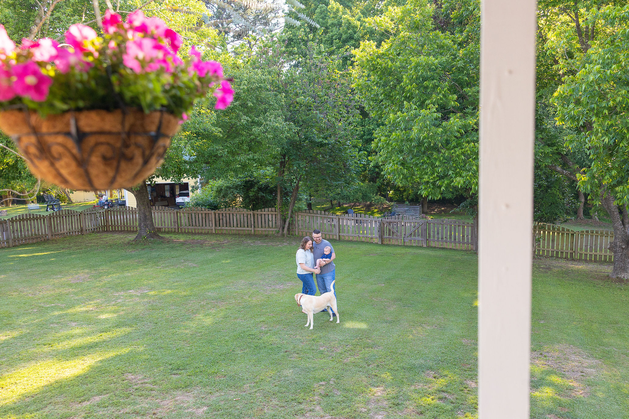 family in yard with dog and baby