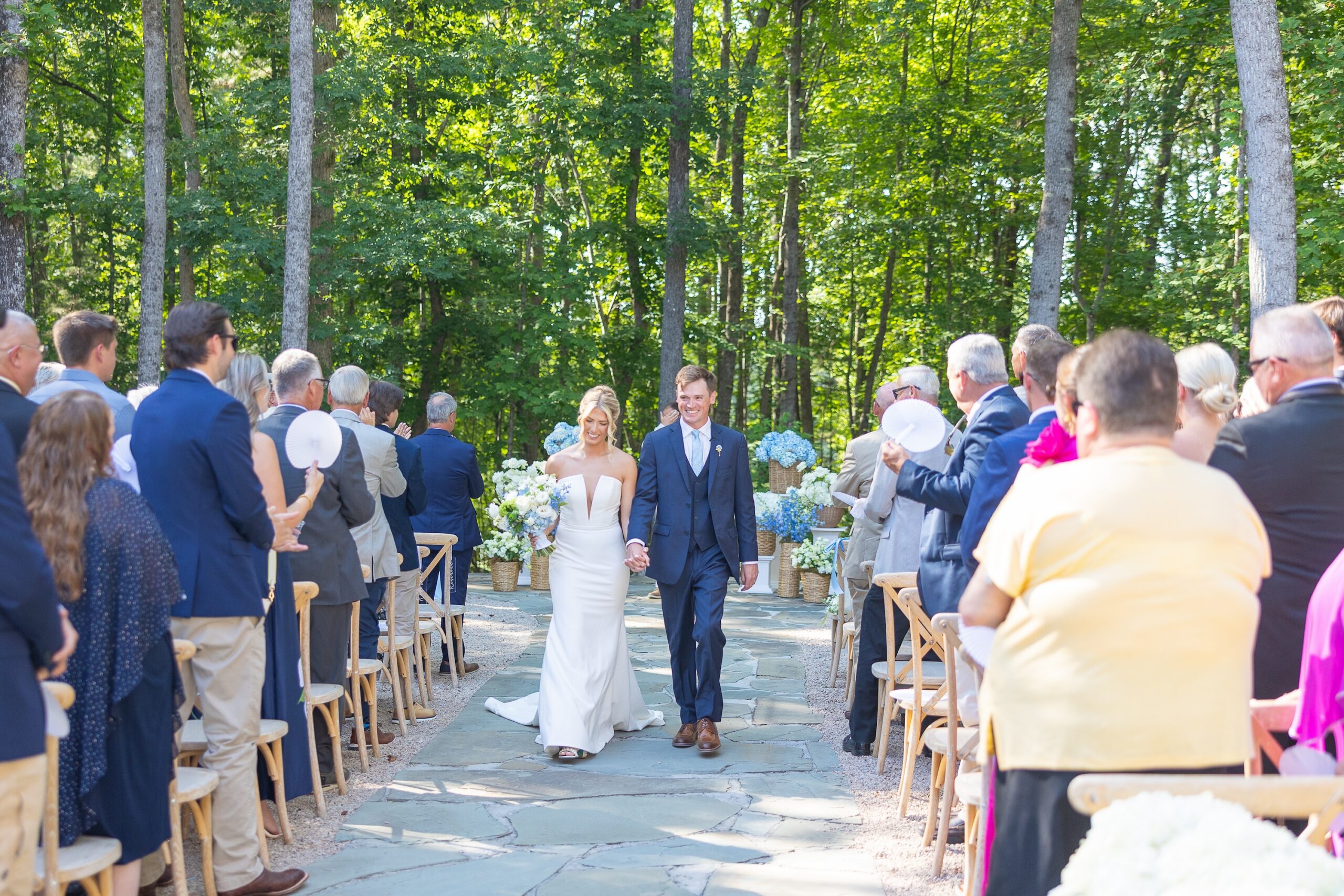 Bride and Groom walking down outdoor wedding aisle