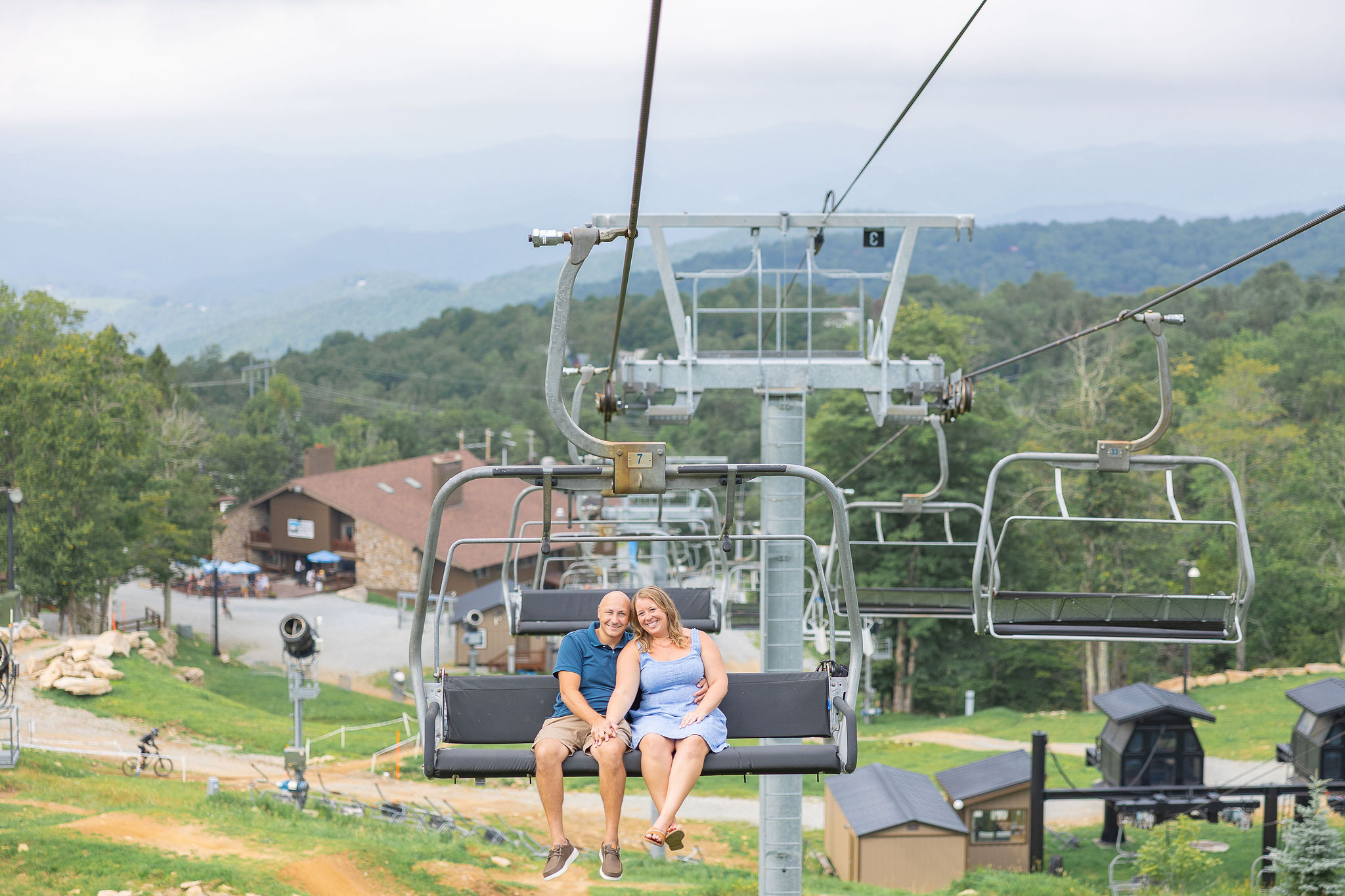couple sitting together in ski chair lift