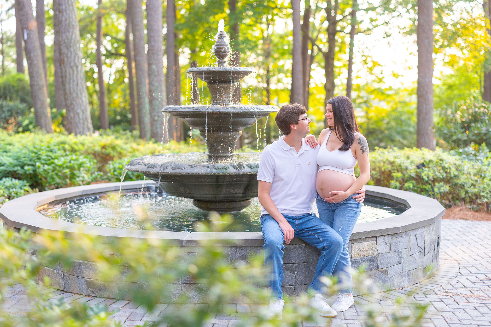 couple sitting on fountain looking at each other