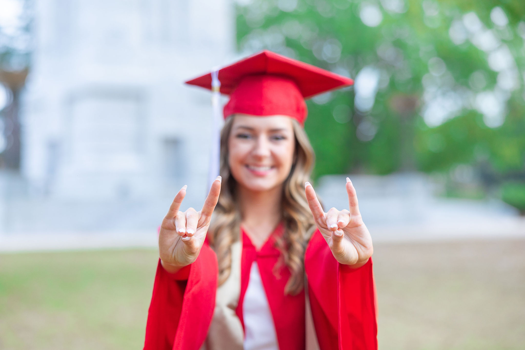 nc state grad holding up wolfpack hands