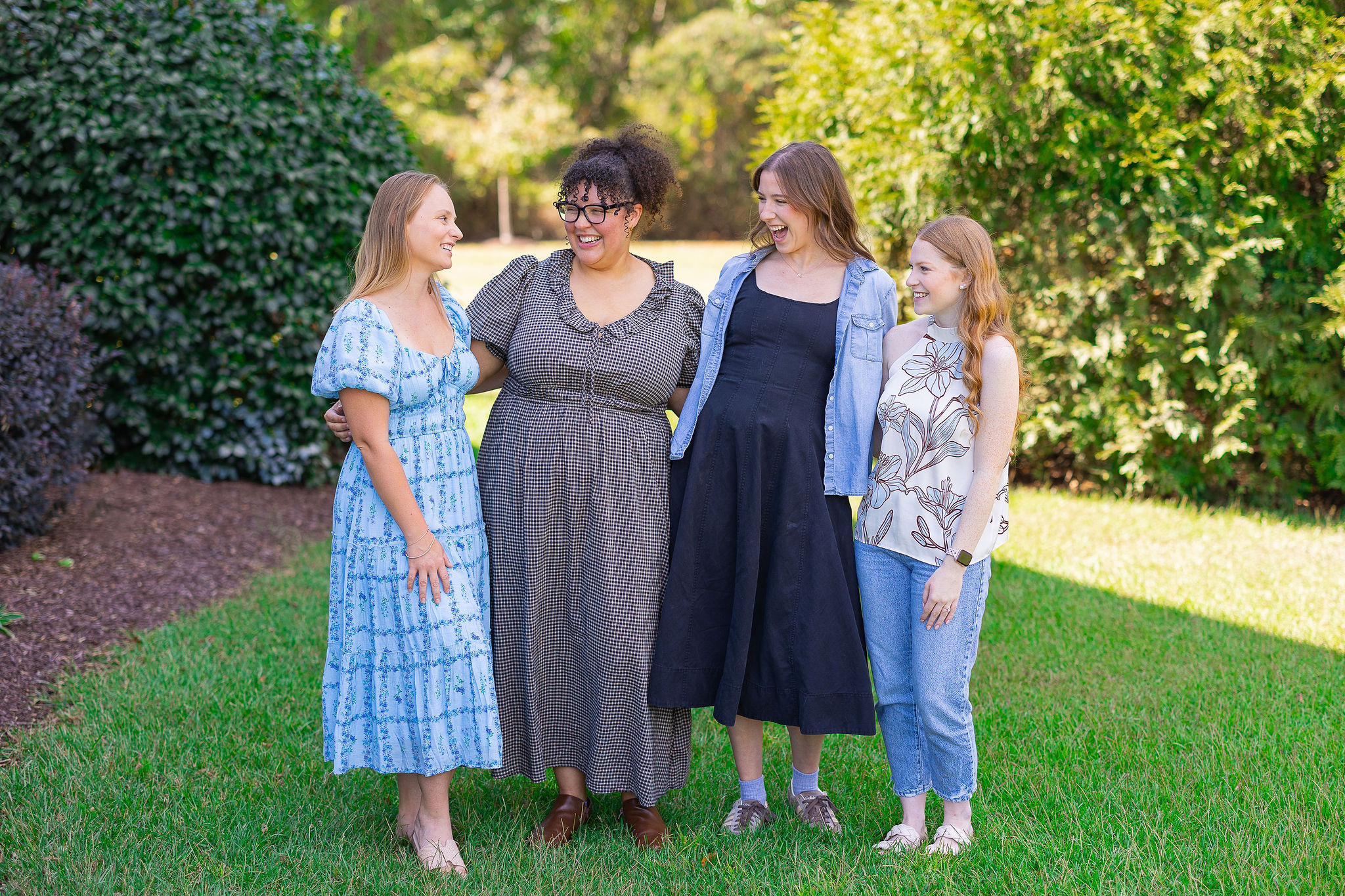 Group of girls laughing standing in field