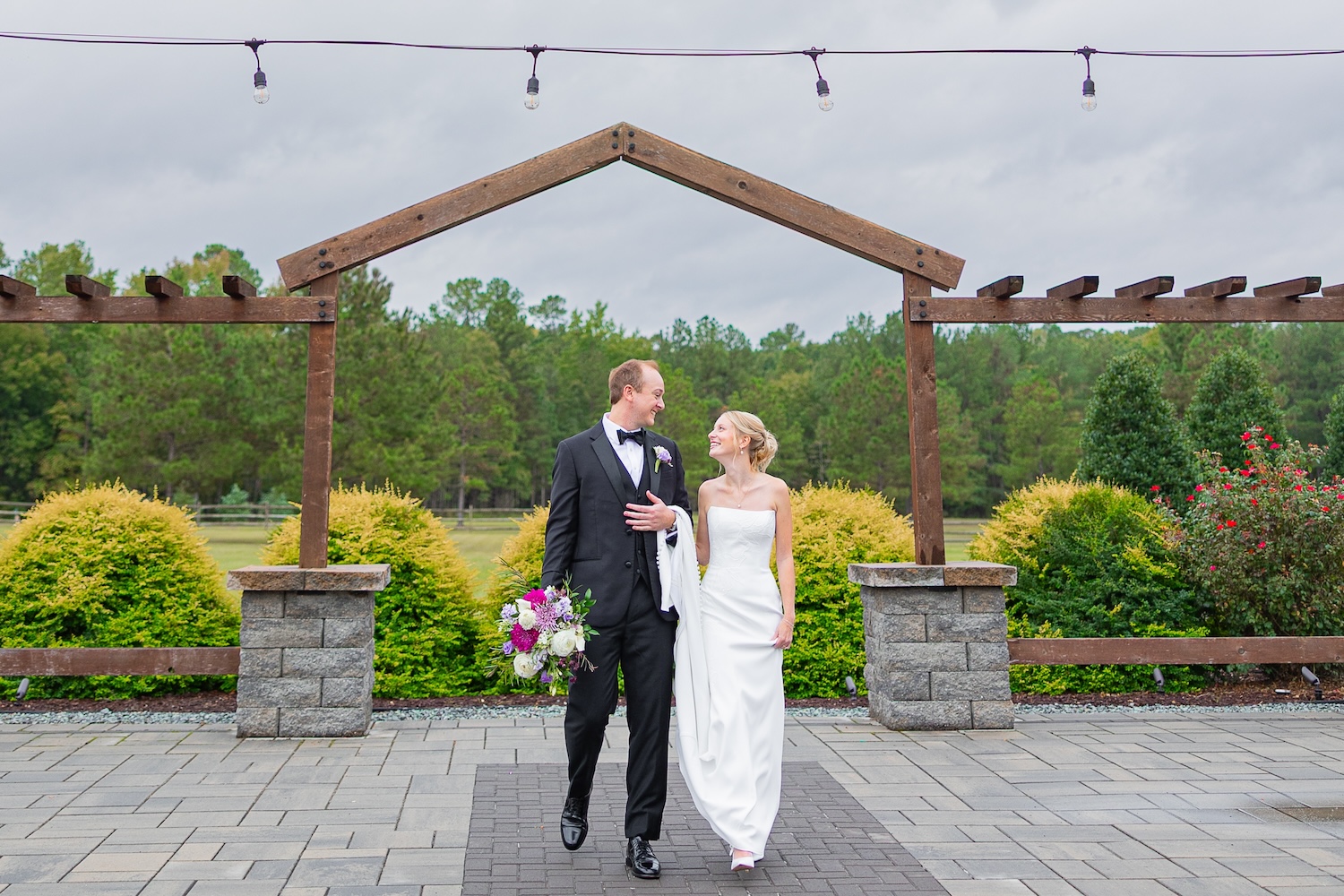 groom holding brides dress