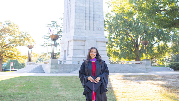 NC State Grad in front of belltower
